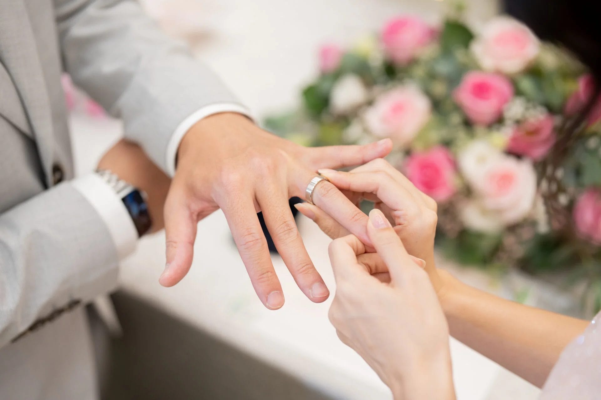 close-up shot of a couple's giving of rings
